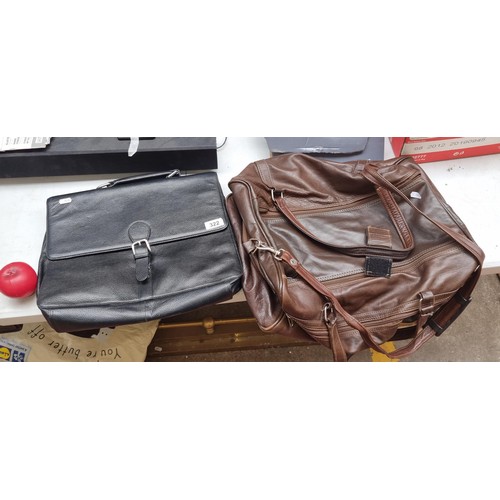 322 - Two leather travel bags including a black laptop and a brown luggage case.