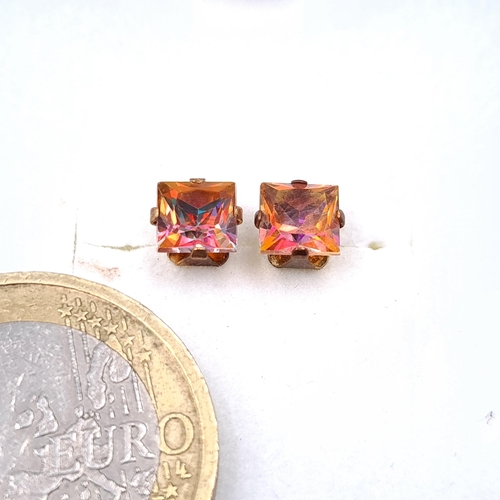 10 - A pair of nine carat gold mystic topaz stone stud earrings. Boxed.