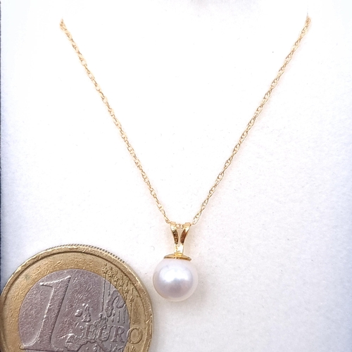 12 - A beautiful lustre pearl drop pendant set with 9ct gold chain. Length - 44 cms. Boxed.