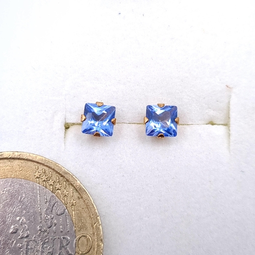 13 - A pair of nine carat gold tanzanite stone stud earrings. Boxed.