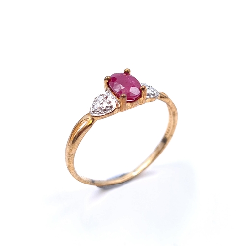 15 - Star Lot : An attractive 9ct gold metal three stone ring set with a bright ruby  stone with gem set ... 