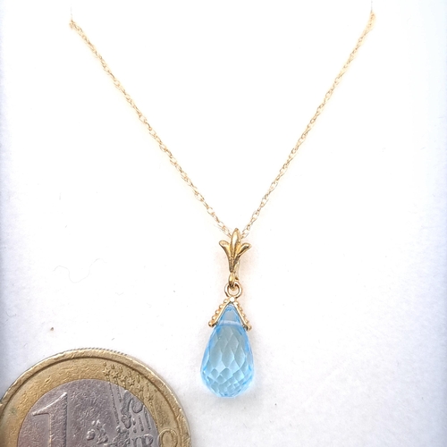 17 - A lovely 9ct gold pear shaped aquamarine stone pendant with9ct  gold chain. Length - 42 cms. Boxed.