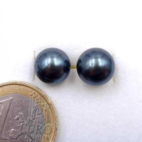 19 - A pair of black pearl nine carat gold stud earrings. Boxed.