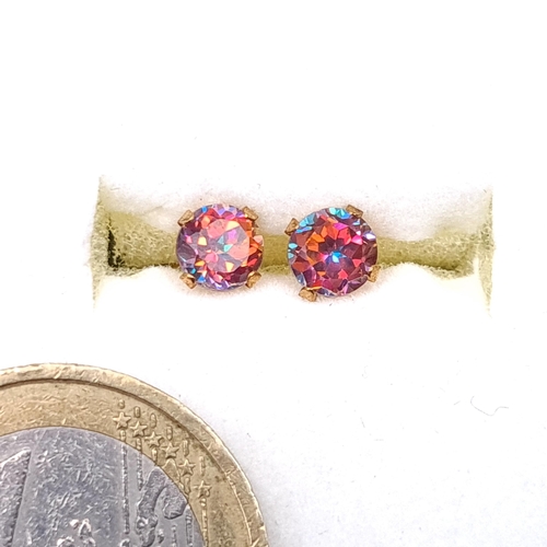 20 - A pair of super pretty sparkly nine carat gold mystic topaz stud earrings. Boxed.