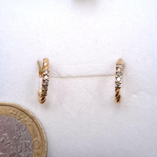 23 - Star Lot : A pair of hoop style diamond set stud earrings (one back missing) set in nine carat gold.... 