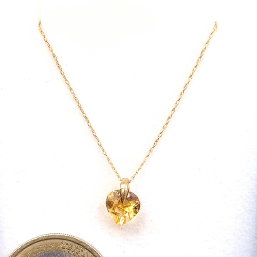 24 - A 9ct gold  heart shaped citrine stone pendant necklace with chain. Length - 42 cms. Boxed.