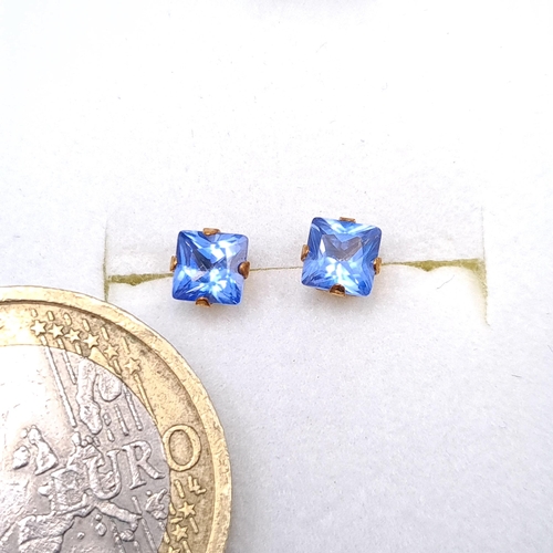 27 - A pair of nine carat gold blue Tanzanite stud earrings. Boxed.