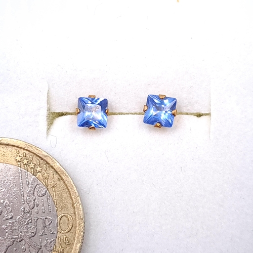 28 - A pair of nine carat gold blue Tanzanite stud earrings. Boxed.