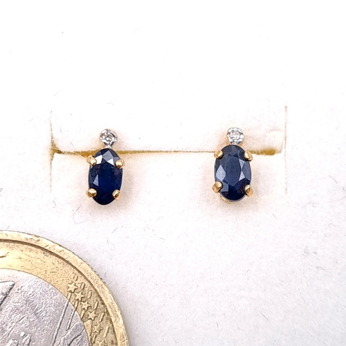 30 - A pair of nine carat gold sapphire stone stud earrings. Boxed.