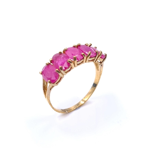 31 - Star Lot : A 10 carat gold ring marked 10K to band set with 5 large ruby stones. Ring size - N. Weig... 