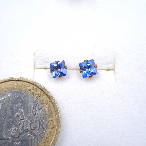 32 - A pair of nine carat gold blue Tanzanite stone stud earrings. Boxed.