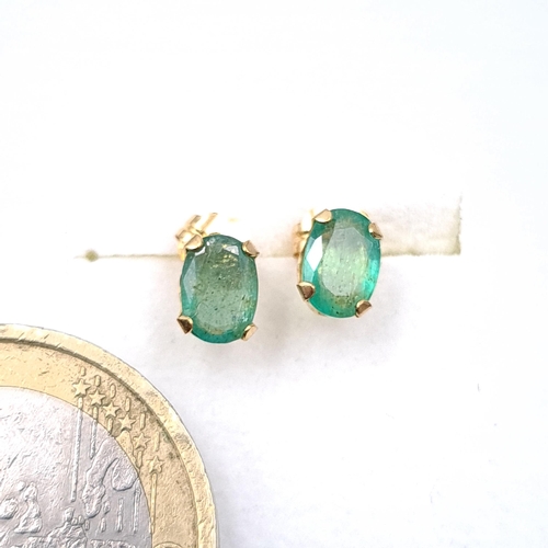 34 - A pair of nine carat emerald stone stud earrings. Boxed.