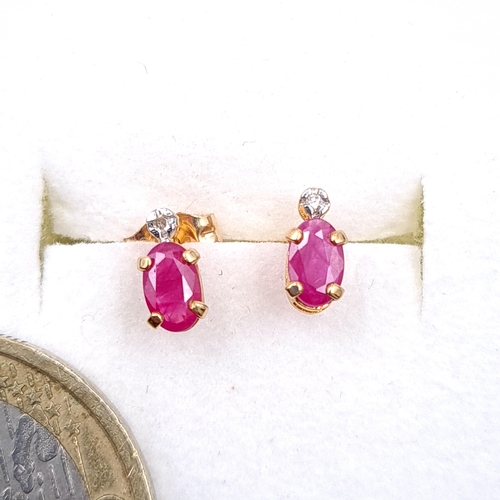 36 - A pair of nine carat gold ruby stone stud earrings. Boxed.