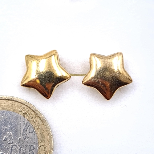 37 - A pair of gold toned star design stud earrings. Boxed.