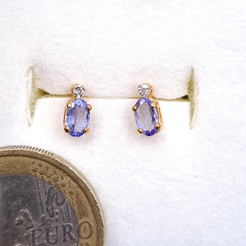 38 - A pair of lovely nine carat gold blue Tanzanite stud earrings. Boxed.