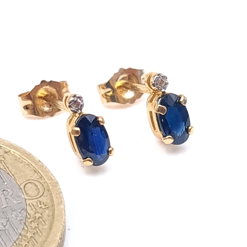 4 - A pair of nine carat gold sapphire stone stud earrings. Boxed.