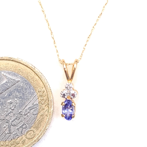 42 - Star Lot : A nice example of a nine carat gold pendant set with blue tanzanite and diamond set stone... 