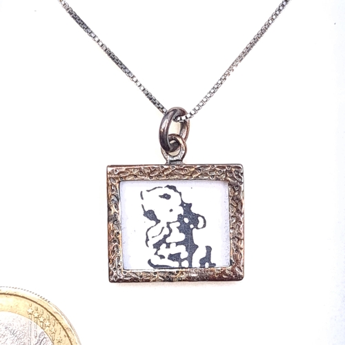 43 - A sterling silver pendant depicting a picture of an infant set with sterling silver chain. Length - ... 