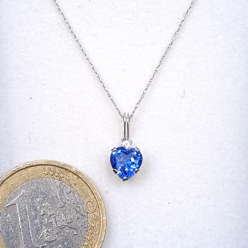 47 - A heart shaped blue tanzanite stone pendant necklace with silver chain. Length - 42 cms. Boxed.