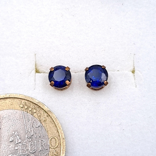 48 - A pair of nine carat gold sapphire stone stud earrings. Boxed.