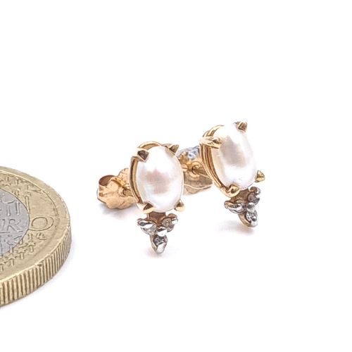 6 - A pair of nine carat gold pearl set stud earrings with lustre earrings  set with diamond accents. We... 