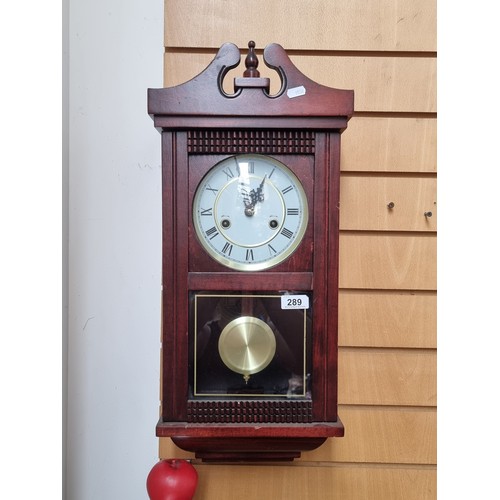 289 - An 8 day wall clock with visible pendulum. Nice and clean example.