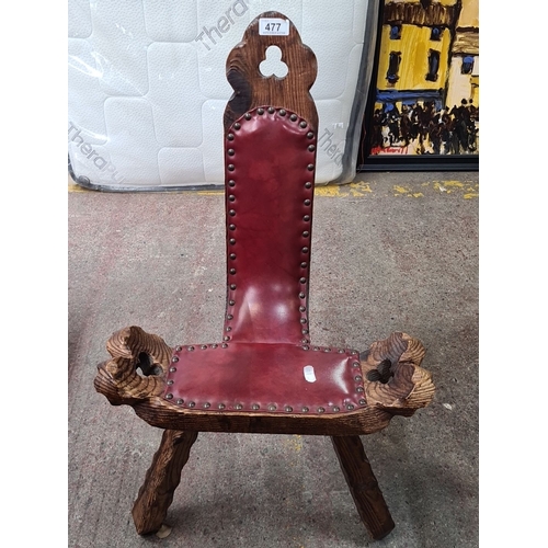 477 - A beautiful hand carved Spanish Elm birthing chair with red leather upholstery and brass stud trim. ... 