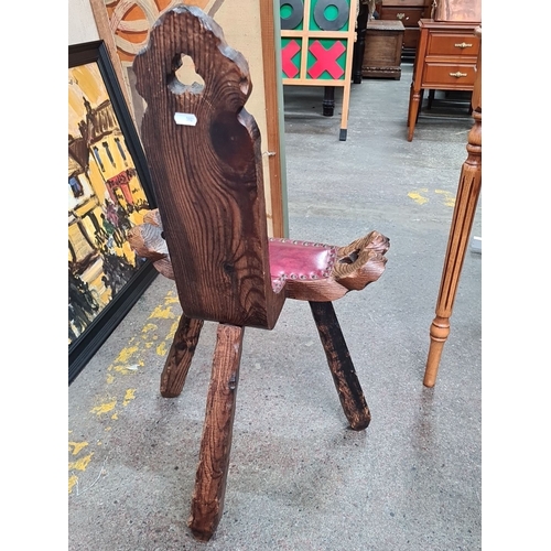 477 - A beautiful hand carved Spanish Elm birthing chair with red leather upholstery and brass stud trim. ... 