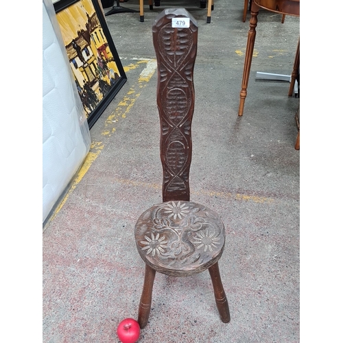 479 - A wonderful antique wooden spinning chair / stool featuring hand carved floral motifs to seat and in... 