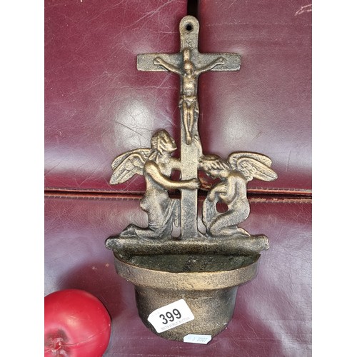 399 - A cast metal holy water font with screw hole for the wall.