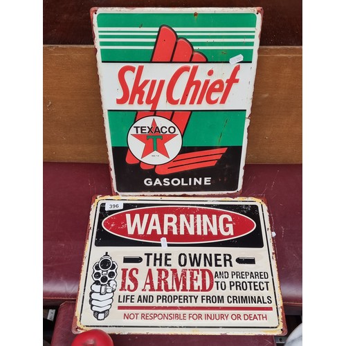 396 - Two Metal wall plaques featuring 'Skychief Texaco Gasoline' and 'Warning: The owner is armed and pre... 