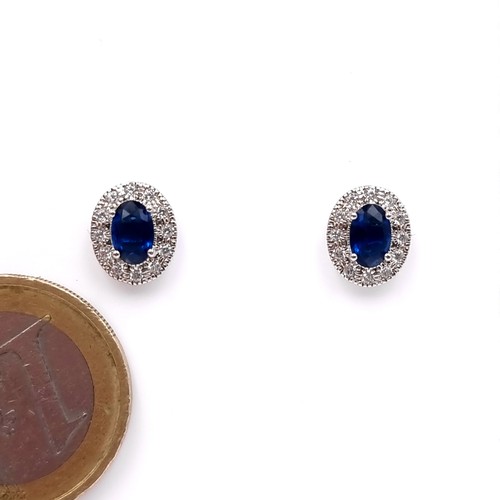 A pair of lovely  sterling silver blue sapphire stone stud earrings with gemstone setting. Boxed.