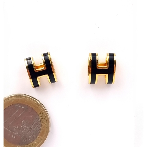 1059 - Star Lot : A stunning pair of designer Hermes studded earrings featuring the H logo with a curved ed... 