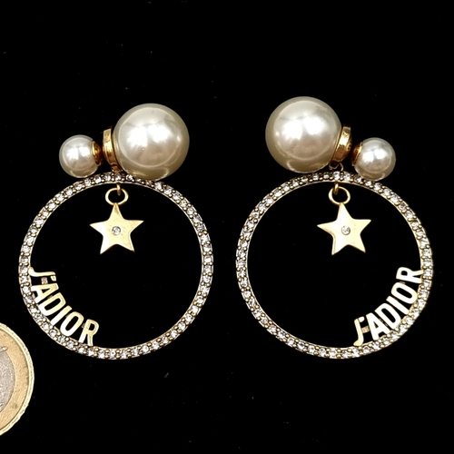 1060 - Star Lot : A fabulous pair of designer Dior earrings composed of white resin pearls, crystal studded... 