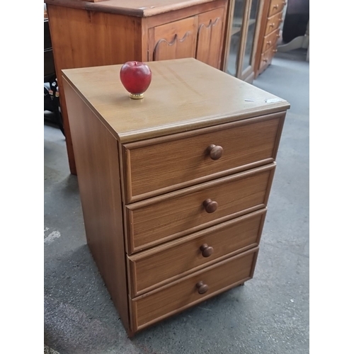 1025 - Four-drawer wooden chest with round knob handles. The chest features simple, clean lines.