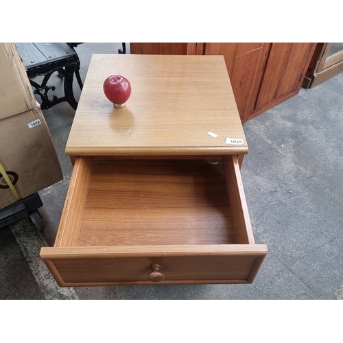 1025 - Four-drawer wooden chest with round knob handles. The chest features simple, clean lines.