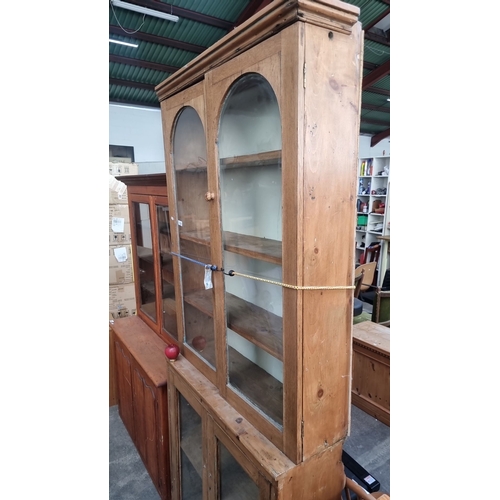 1027 - Star lot : Antique pine display cabinet with glass doors and shelving, featuring Victorian architect... 