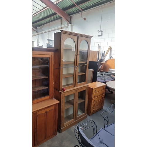 1027 - Star lot : Antique pine display cabinet with glass doors and shelving, featuring Victorian architect... 