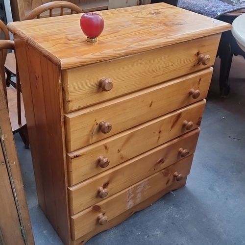 1028 - Solid pine chest of drawers with five spacious drawers, featuring rounded wooden knobs and a natural... 