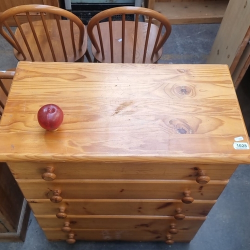 1028 - Solid pine chest of drawers with five spacious drawers, featuring rounded wooden knobs and a natural... 