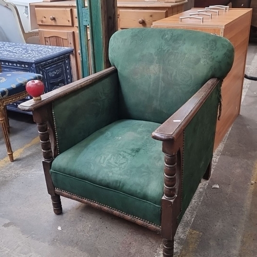 1032 - Victorian armchair with green upholstery, highlighted by beaded wooden detail on the arms and backre... 