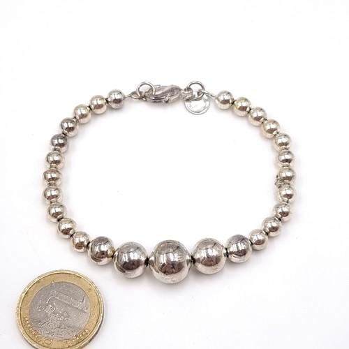 1085 - A sterling silver 925 graduating ball beaded bracelet with lobster clasp. Weight 12.05 grams.