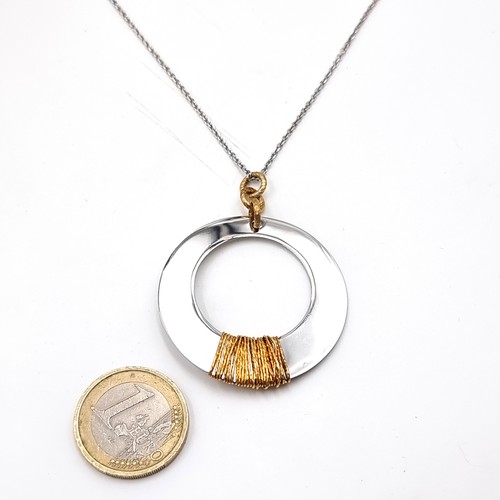 1089 - A silver and gold pendant necklace. Necklace stamped 925. Weight 9.04 grams. Length of chain 44cm.