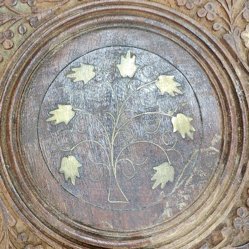 474 - An elaborately Hand-carved Indian wooden folding table with intricate floral leaf designs and a cent... 