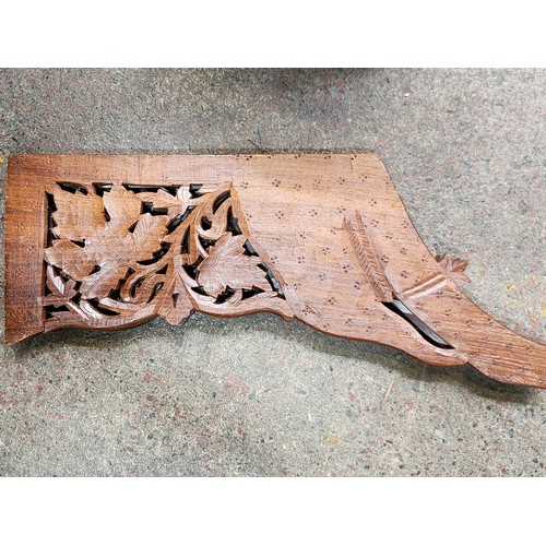 474 - An elaborately Hand-carved Indian wooden folding table with intricate floral leaf designs and a cent... 