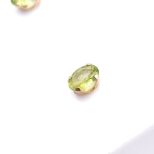 14 - A pair of nine carat gold Peridot stone stud earrings. Boxed.