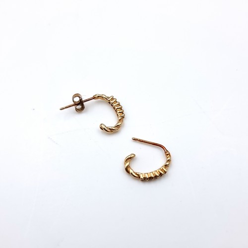 23 - Star Lot : A pair of hoop style diamond set stud earrings (one back missing) set in nine carat gold.... 