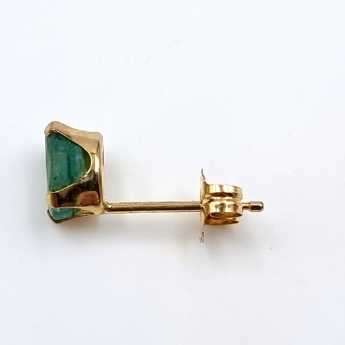 34 - A pair of nine carat emerald stone stud earrings. Boxed.