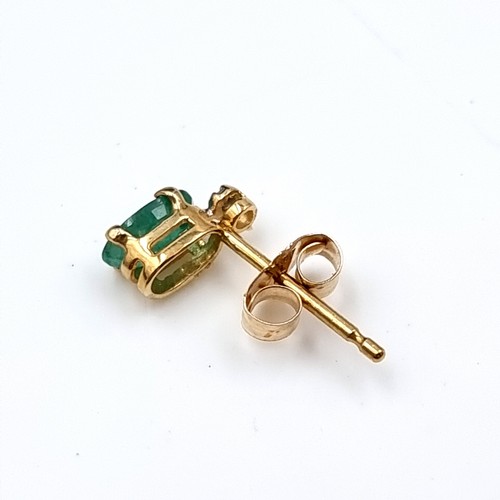 35 - A pair of nine carat gold Emerald stud earrings. Boxed.