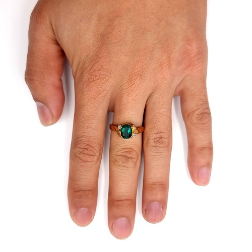 22 - Star Lot : A 10k gold ring marked to band with green gemstone setting set with gemstone accents. Rin... 